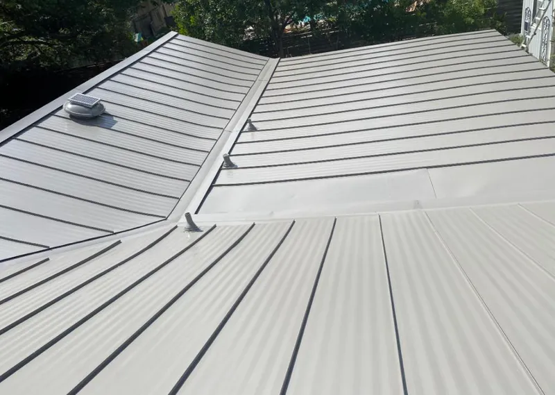 Solar attic fan installed on a metal roof for Roof Ventilation in Azle